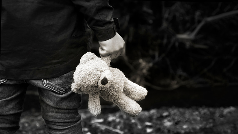 boy holding a teddy bear