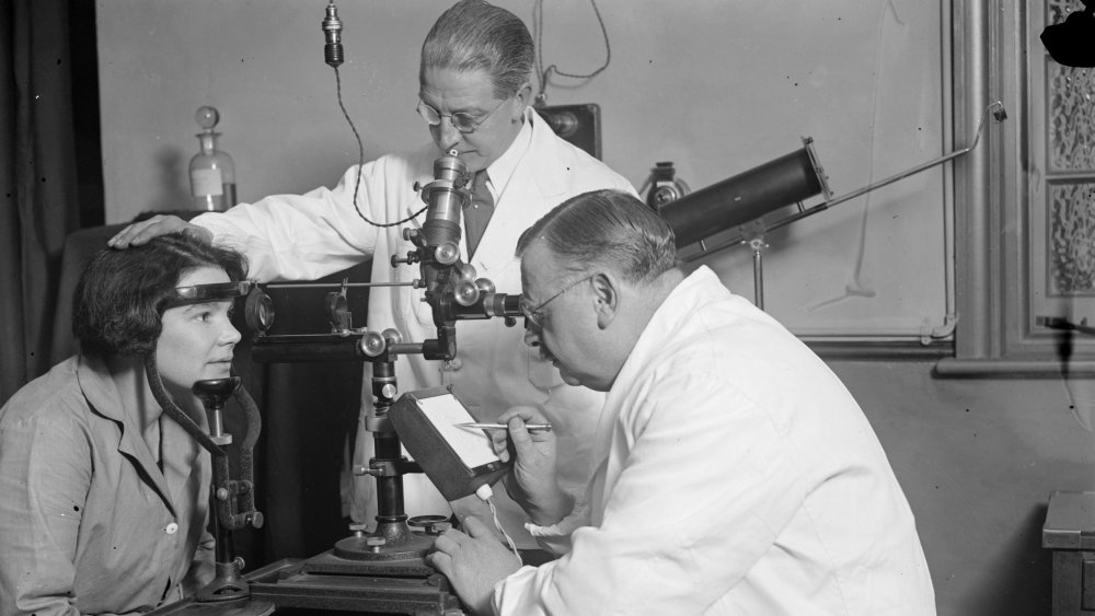 Doctors testing new medical equipment on a patient in 1927