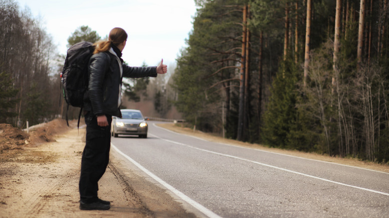 Young man hitchhiking