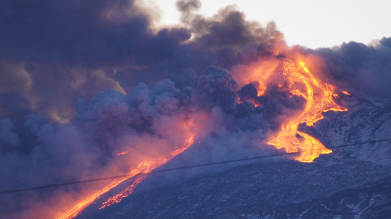 Mount Etna erupting with smoke lava flows