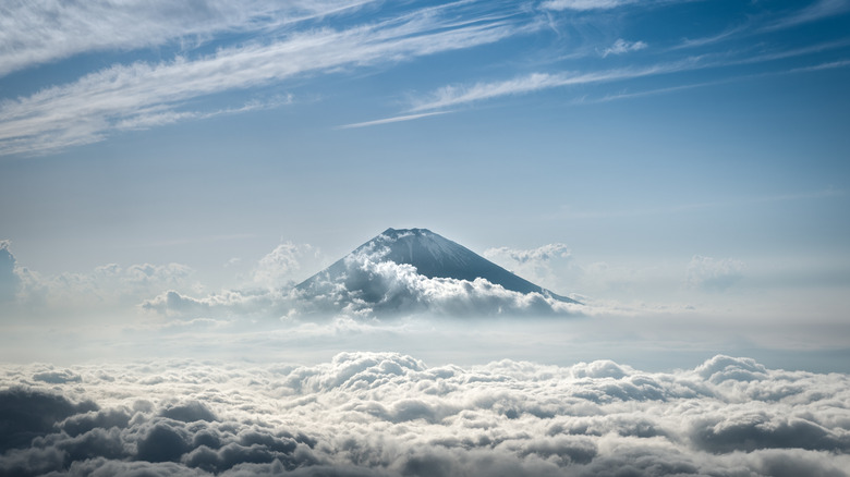 aerial view of Mount Fuji seen over clouds