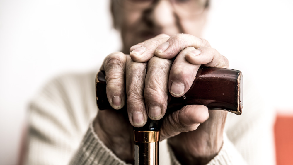 Elderly woman with cane 