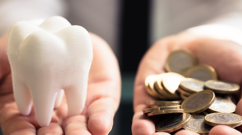 A tooth next to a pile of money