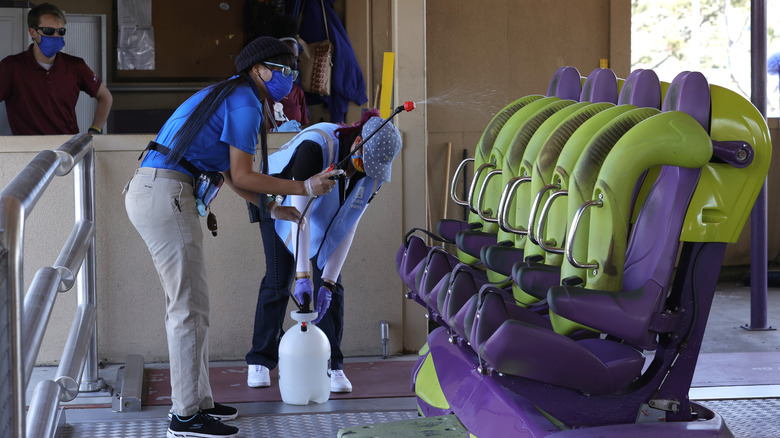 workers cleaning a roller coaster