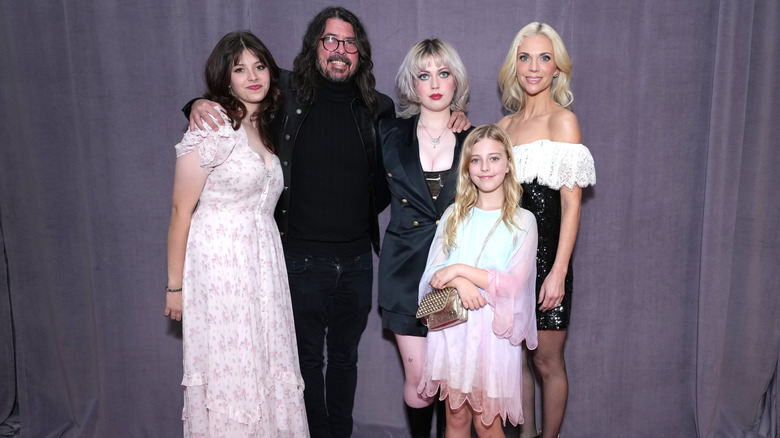 Dave Grohl and wife Jordyn Blum posing with their three daughters in 2023