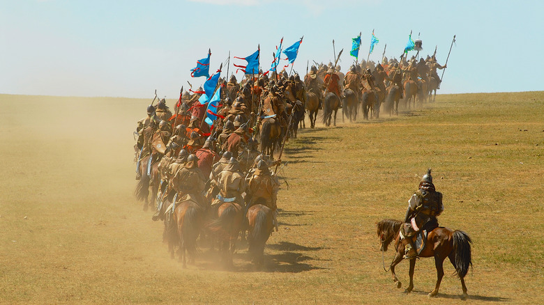 mongol horse riders riding away