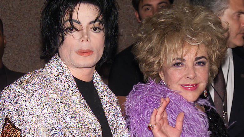 Elizabeth Taylor waving with Michael Jackson