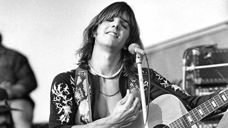 Gram Parsons playing guitar eyes closed