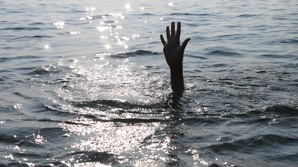 Hand sticking out of the water