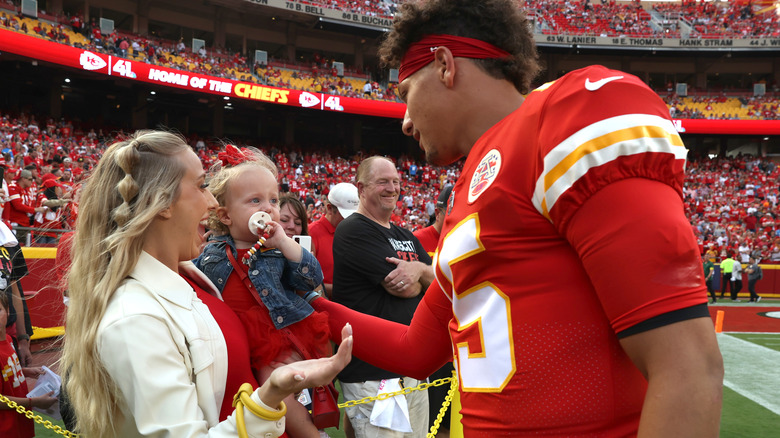 Brittany, Sterling, and Patrick Mahomes on the sidelines of a Chiefs game