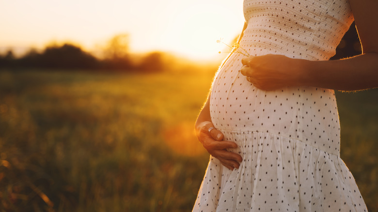 pregnant woman holding belly