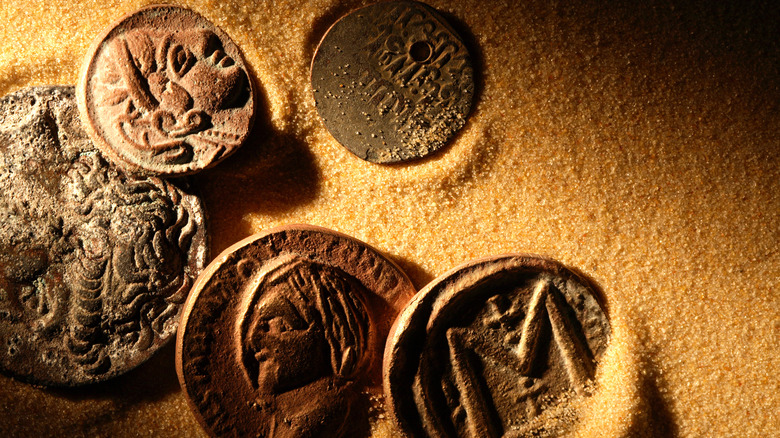 Ancient coins on sand