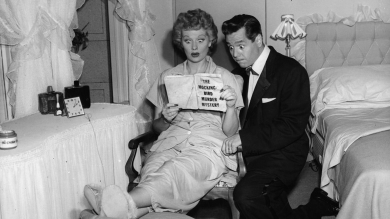 Lucy and Ricky Ricardo looking shocked reading