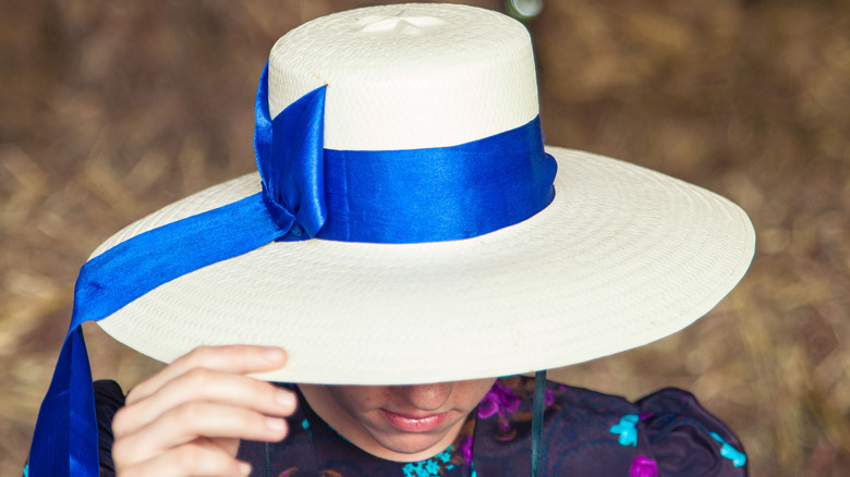 Mennonite woman hat over face