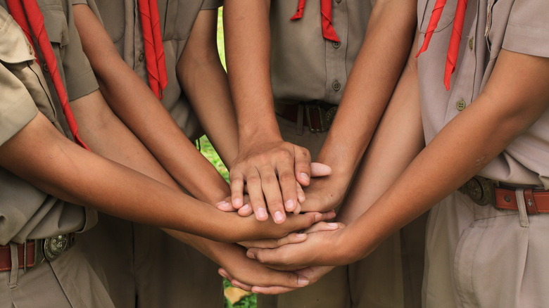 Boy Scouts hands pile teamwork