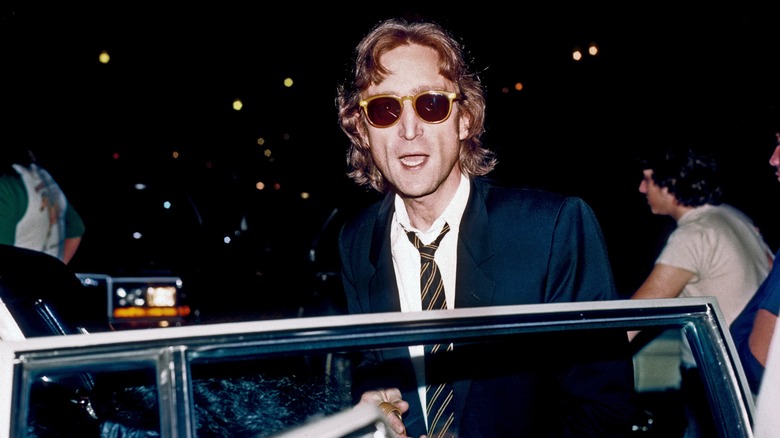 John Lennon getting in a car