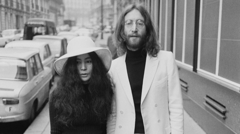 John Lennon and Yoko Ono posing