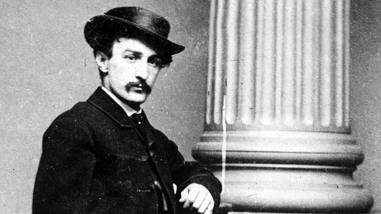 John Wilkes Booth at a column