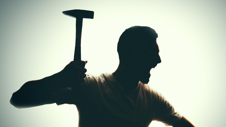 silhouette of man wielding hammer