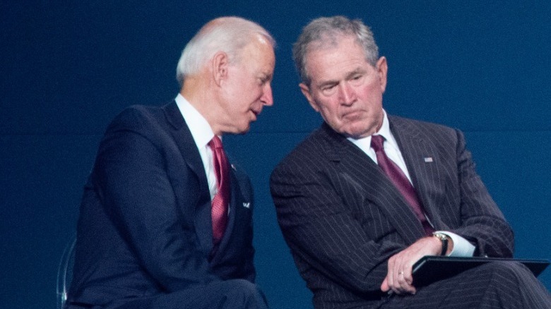 Biden whispers to George W. Bush