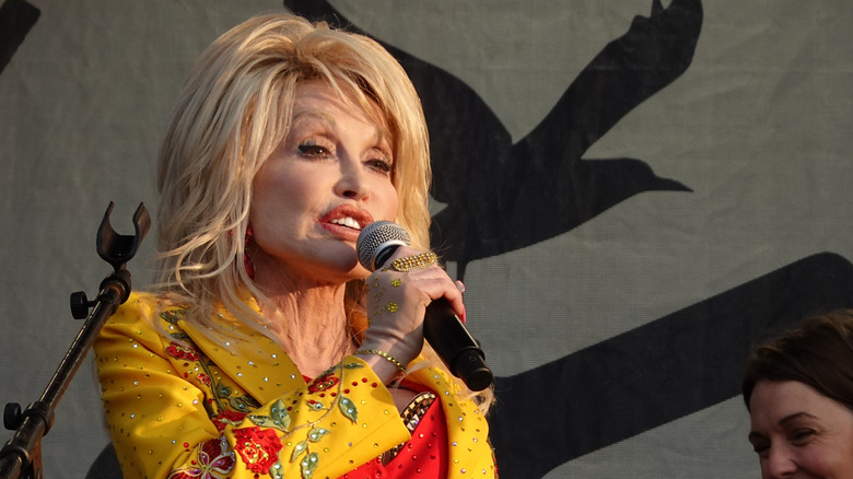 Dolly Parton holding a microphone