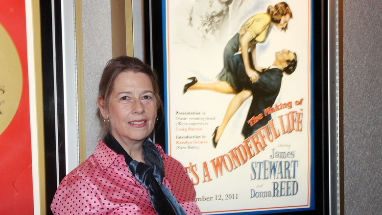 Owen poses with mother's movie poster