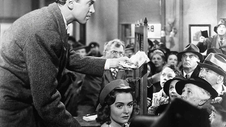 Jimmy Stewart handing cash to crowd