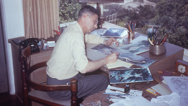 Dr. Seuss illustrating pages at a desk