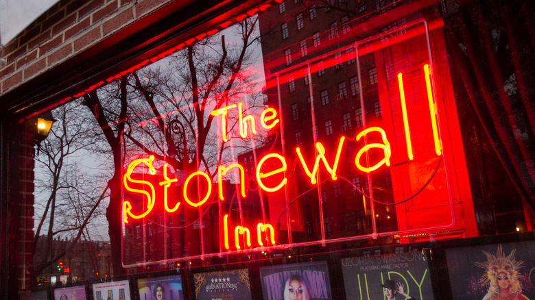 Red neon window sign Stonewall Inn