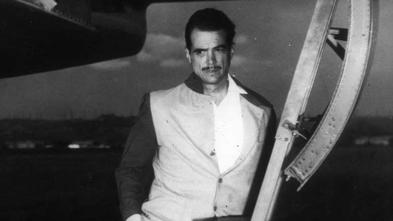 Howard Hughes standing on ladder