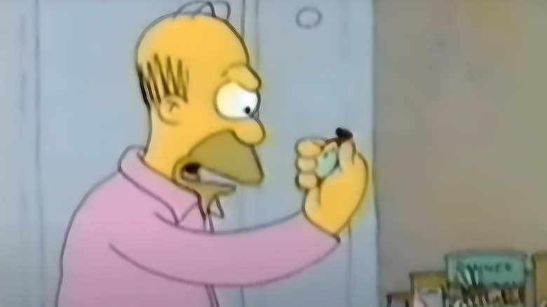 Homer looks at stopwatch