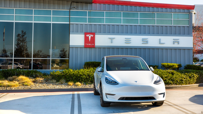 Tesla factory with Tesla vehicle parked outside