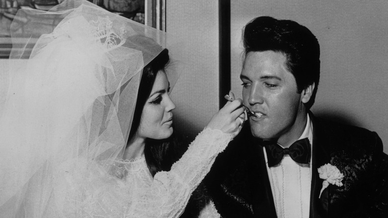 Priscilla feeding Elvis their wedding cake