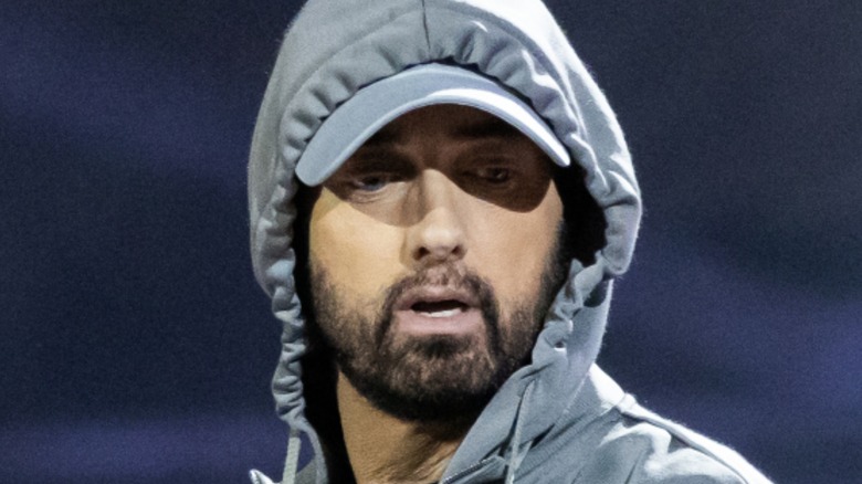 eminem looking down on stage in hood and hat