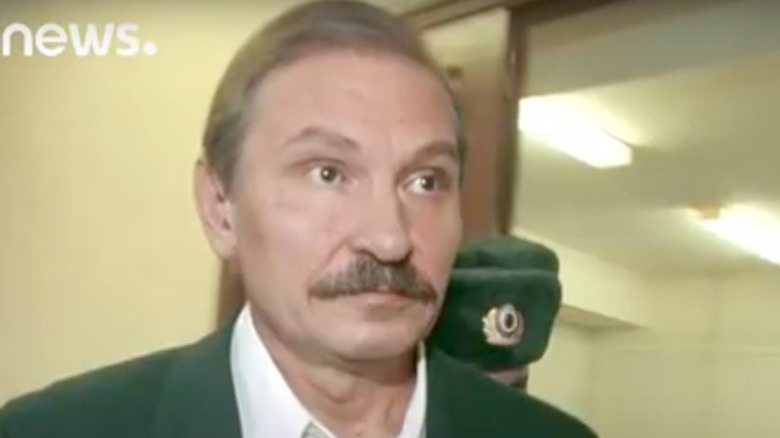 Nikolay Glushkov moustache escorted by guard