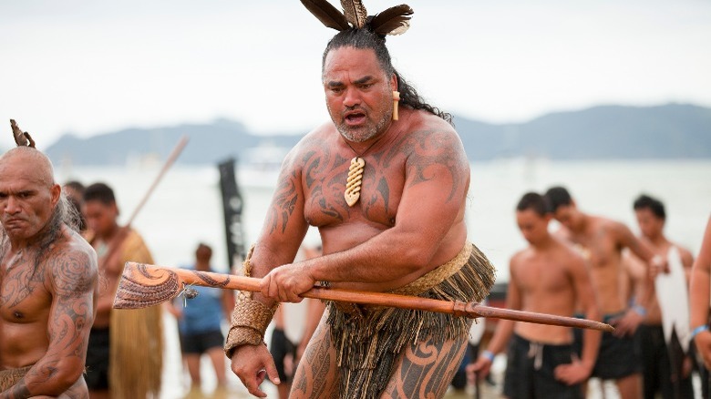 Māori warrior on beach with tattoos