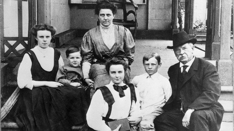 Esther Cleveland sitting on a porch with her family