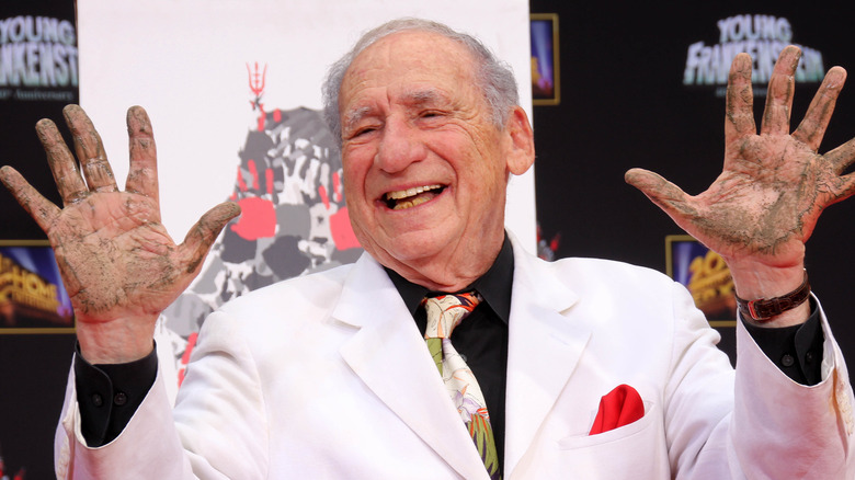 Mel Brooks posing with cement on his hands