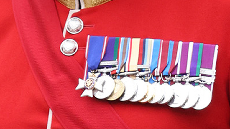 row of medals on red jacket