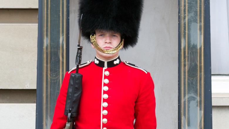 A Grenadier guard black fur hat red coat