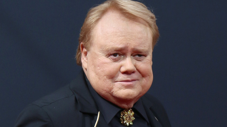 Louie Anderson smirking wearing brooch