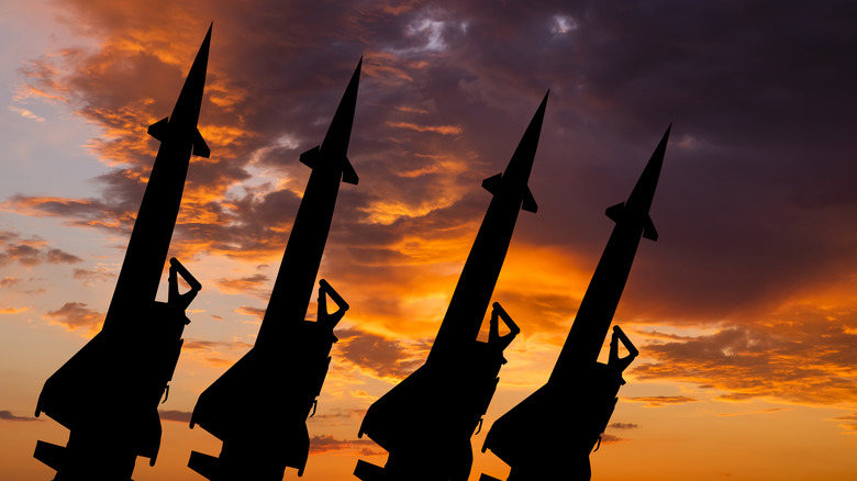 MIssiles silhouetted against setting sun