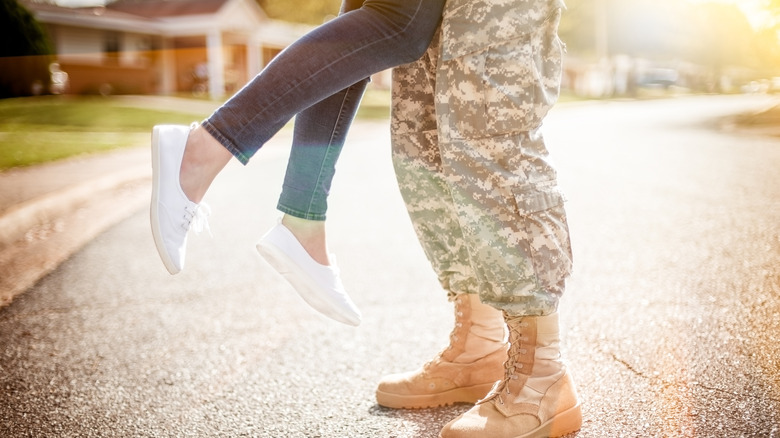 A solider holding a woman