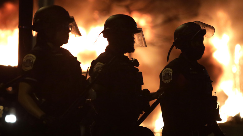 Three Minneapolis police officers' silhouettes 