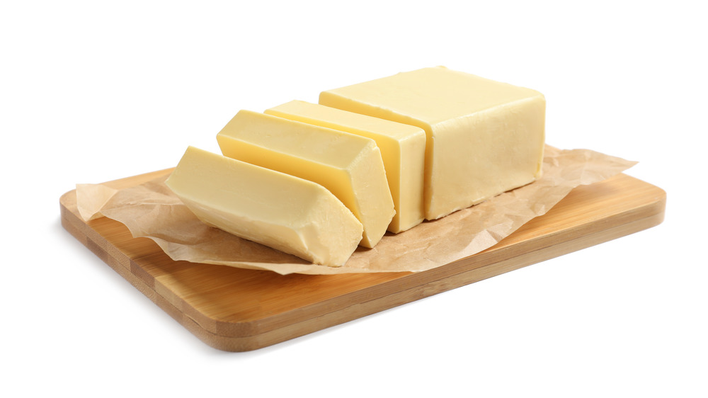 Block of butter on wooden board