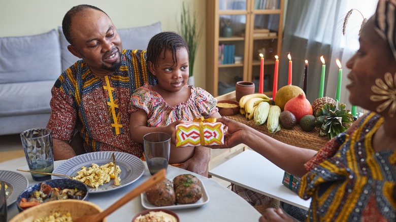 Family at the dinner table giving gifts