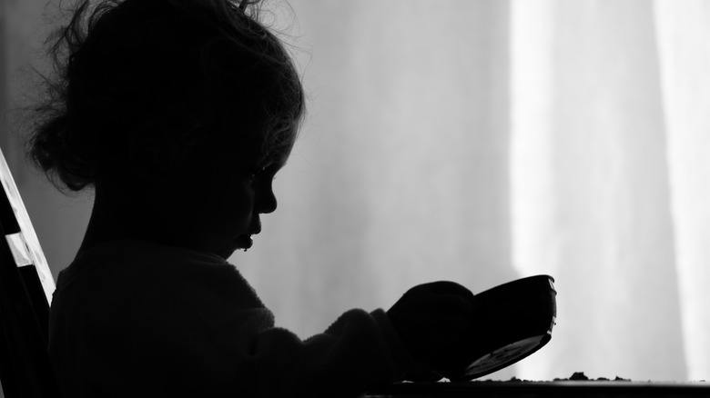 Hungry child peering into bowl