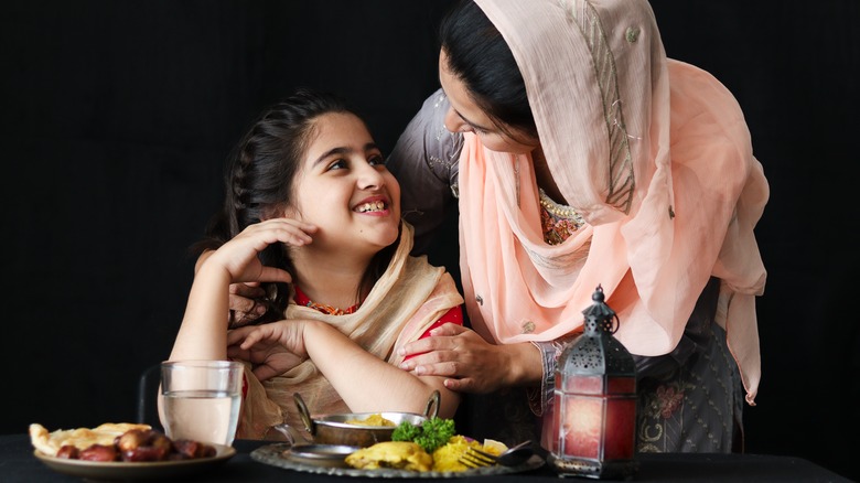 Pakistani mother and daughter cooking