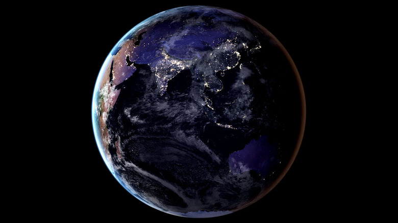 NASA "black marble" image of Earth at night showing city lights.