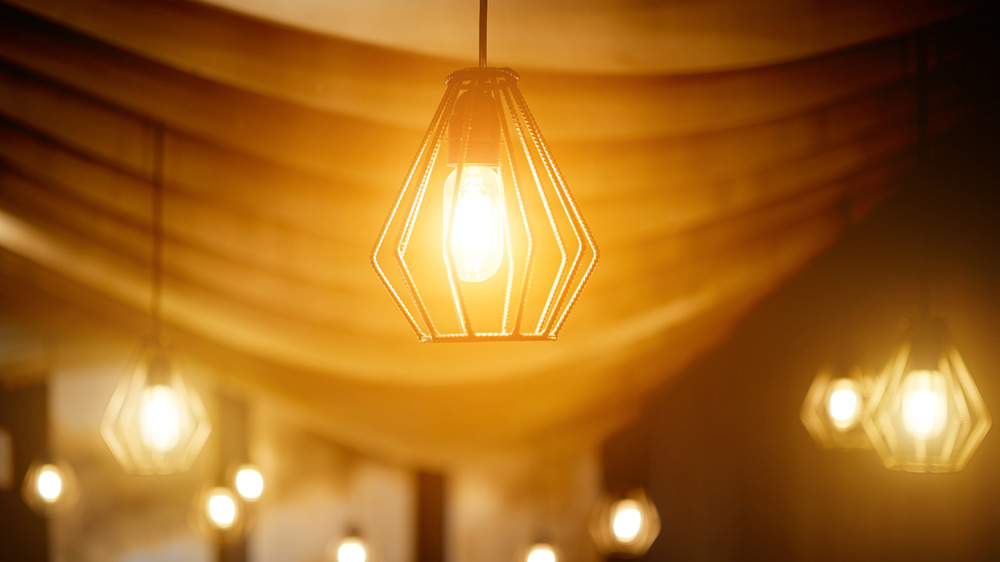 orange light bulbs hanging from draped ceiling 